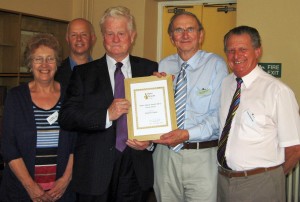 Tim Crowther (2nd from right) presents the certificate to (from left) Lyn, Ryan, John Moorby, Trevor Dean and Dave Wainman of Grange Area Trust