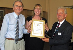 Tim Crowther (left) presents the certificate to Laura Richardson of Elmbridge Borough Council and David Tipping of Cobham Conservation & Heritage Trust