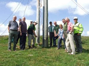 Members of the Dartmoor Preservation Association and the Dartmoor National Park Authority assisting Western Power Distribution in removing the last pole on the line at Devil’s Elbow. Photo: DNPA.