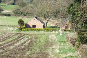 The footpath from the south. It runs straight on past the house; the diversion was around the field edge to the left.