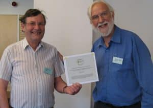 Peter Newman (left) receiving his award from OSS chairman Graham Bathe (right)