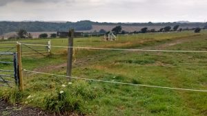 Footpath sign points to fenced-off area