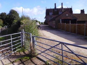 After: the fence has been set back to restore the path to its full width