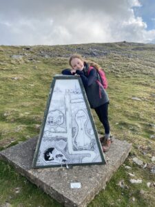 Patricia at a capped mineshaft on Bakestonedale Moor. The artwork depicts the local mining activity. Image John Rogers